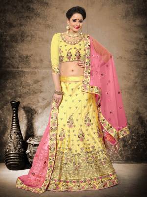 Have A Graceful And Attractive Look With This Heavy Designer Lehenga Choli In Yellow Color Paired With Contrasting Pink Colored Dupatta. Its Blouse And Lehenga Are Fabricated On Velevt Satin Paired With Net Fabricated Dupatta. Its Bright Colors And Embroidery Will Earn You Lots Of Compliments From Onlookers.