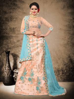 Here Are Very Pretty Unique Shades To Add Up Into Your Wardrobe With This Heavy Designer Lehenga Choli In Light Peach Color Paired With Contrasting Sky Blue Colored Dupatta. Its Blouse And Lehenga Are Fabricated On Art Silk Paired With Net Fabricated Dupatta. Buy It Now.
