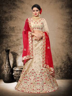 Most Fond And Evergreen Combination In Ethnic Wear IS Here With This Heavy Designer Lehenga Choli In Beige Color Paired With Red Colored Dupatta. Its Blouse And Lehenga Are Fabricated On Art Silk Paired With Net Fabricated Dupatta. It Is Beautified With Heavy Embroidery All Over It.