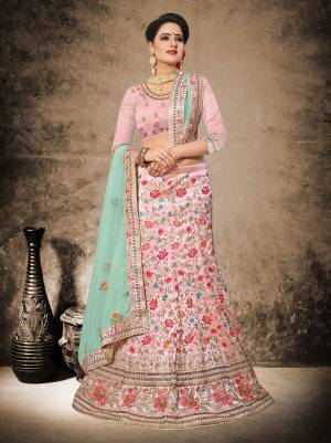 If Your Are Fond Of Light Shades Than Grab This Heavy Designer Lehenga Choli In Light Pink Color Paired with Contrasting Aqua Blue Colored Dupatta. Its Blouse And Lehenga Are Fabricated On Art Silk Paired With Net Fabricated Dupatta. This Lehenga Choli Will Give A Very Pretty Look To Your Personality. Buy Now.