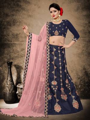 Enhance Your Personality Wearing This Heavy Designer Lehenga Choli In Navy Blue Color Paired With Contrasting Light Pink Colored Dupatta. Its Blouse And Lehenga Are Fabricated On Velvet Satin Paired With Net Fabricated Dupatta. This Designer Lehenga Choli Has Unique Patterned Embroidery Which Will Earn You Lots OF Compliments From Onlookers. 
