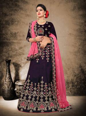 Dark Shade Gives An Enhanced Look To Your Personality, Grab this Beautiful Heavy Designer Lehenga Choli In Dark Purple Color Paired With Pink Colored Dupatta. Its Blouse And Lehenga Are Fabricated On Velvet Satin Paired With Net Fabruicated Dupatta. This Lehenga Choli Ensures Superb Comfort All Day Long. 