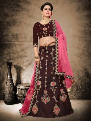 For A Royal Look, Grab This Heavy Designer Lehenga Choli In Maroon Color Paired With Contrasting Pink Colored Dupatta. Its Blouse And Lehenga Are fabricated On Velvet Satin Paired With Net Fabricated Dupatta. It Is Beautified With Minimal Embroidery Making It Rich And Elegant .