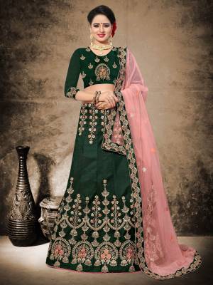You Will Definitely Earn Lots Of Compliments Wearing This Designer Lehenga Choli In Pine Green Color Paired With Contratsing Light Pink Colored Blouse. This Blouse And Lehenga Are Fabricated On Velvet Satin Paired With Net Fabricated Dupatta. Buy It Now.