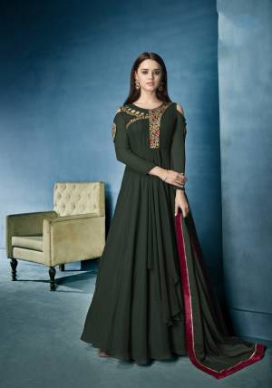 Seasons Hot Favourite Pattern Is Here With This Designer Floor Length Suit In Dark Green Colored Top With Cold Shoulder Pattern Paired With Dark Green Colored Bottom And Dupatta. Its Top Is Fabricated On Georgette Paired With Santoon Bottom And Chiffon Dupatta.
