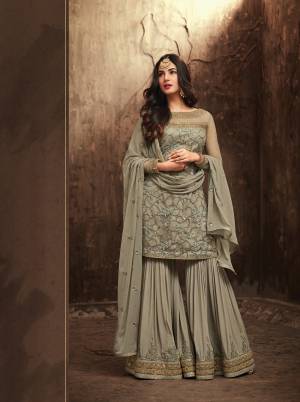 Mix Of Two Colors Makes A Great Shade And Same Is Here With This Designer Suit In Greenish Grey Color. Its Top IS Fabricated On Net Paired With Silk Georgette Bottom And Chiffon Dupatta.  Its All Three Fabrics Ensures Superb Comfort All Day Long. Buy Now.