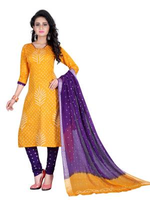 Bright And Visually Appealing Color Is Here With This Pretty Dress Material In Yellow Colored Top Paired With Contrasting Purple Colored Bottom And Dupatta. This Dress Material Is Fabricated On Satin Cotton Beautified With Bandhani Prints all Over It. Buy This Now.