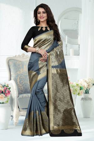Flaunt Your Rich And Elegant Taste Wearing This Silk Saree In Grey Color Paired With Black Colored Blouse. This Saree Is Fabricated On Banarasi Art Silk Paired With Art Silk Fabricated Blouse. It Has Bold Weave Over The Saree. 
