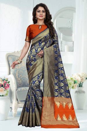 Here Is Lovely Silk Saree In Blue Color Paired With Contrasting Rust Orange Colored Blouse. This Saree Is Fabricated On Banarasi Art Silk Paired With Art Silk Fabricated Blouse. It Beautified With Weave All Over Also Its Silk Fabric Will Give A Rich Look To Your Personality. 