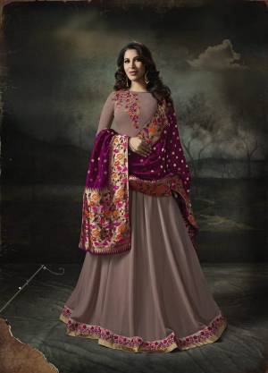 New And Unique Shade In Purple Is Here With This Mauve Colored Designer Floor Length Suit Paired With Mauve Colored Bottom And Contrasting Magenta Pink Colored Dupatta. Its Top Is Fabricated On Georgette Paired With Santoon Bottom And Banarasi Art Silk Dupatta. Buy Now.