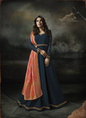 You Will Definitely Earn Lots Of Compliments Wearing This Designer Floor Length Suit In Prussian Blue Color Paired With Prussian Blue Colored Bottom And Contrasting Dark Peach Colored Dupatta. This Elegant Looking Suit IS Suitable For all Occasion Wear.