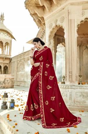 Give A Royal Look To Your Personality With This Designer Saree In Maroon Color Paired With Maroon Colored Blouse. This Saree Is Fabricated On Chiffon Silk Paired With Art Silk Fabricated. It Is Beautified With Embroidered Motifs And Lace Border.