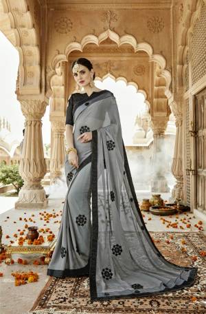 Rich And Elegant Looking Designer Saree Is Here In Grey Color Paired With Black Colored Blouse. This Saree Is Fabricated On Silk Chiffon Paired With Art Silk Fabricated Blouse. It Has Pretty Embroidered Motifs All Over The Saree.