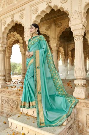 Add This Pretty Shade In Blue To Your Wardrobe With this Saree In Turquoise Blue Color Paired With Sea Green Colored Blouse. This Saree Is Fabricated On Chiffon Silk Paired With Art Silk Fabricated Blouse. It Has Attractive Lace Border Making The Saree Attractive.