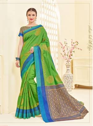 Celebrate This Festive Season Wearing This Saree In Green Color Paired With Contrasting Blue And Gold Blouse. This Saree Is fabricated On Art Silk Paired With Brocade Fabricated Blouse. Buy this Saree Now.