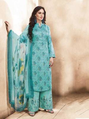 Beautiful Shade In Blue Is Here With This Semi-Stitched Suit In Turquoise Blue Color. Its Top Is Fabricated On Silk Cotton Paired With Satin Cotton Bottom And Chiffon Dupatta. It IS Beautified With Prints And Embroidery. Buy Now.