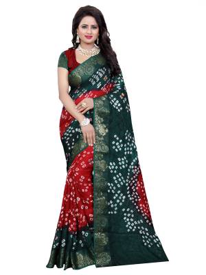 Add This Pretty To Your Wardrobe In Teal Green And Maroon Color Paired With Maroon Colored Blouse. This Saree And Blouse Are Fabricated On Art Silk Beautified With Bandhani Prints. It Is Light Weight And Easy To Drape. 