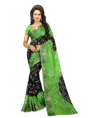 For Your Semi Casual Wear, Grab This Lovely Saree In Green And Black Color Paired With Green Colored Blouse. This Saree And Blouse are Fabricated On Art Silk Beautified With Bandhani Prints All Over It.
