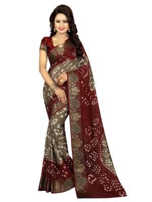 For A Royal And Elegant Look, Grab This Pretty Saree In Grey And Maroon Color Paired With Maroon Colored Blouse. This Saree And Blouse Are Fabricated On Art Silk Beautified with Bandhani Prints. Its Rich Color Combination Will Earn You Lots Of Compliments From Onlookers. Buy Now.