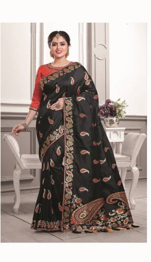 Bold And Beautiful Look Is Here With This Designer Silk Saree In Black Color Paired With Red Colored Blouse. This Saree And Blouse are Fabricated On Art Silk Beautified With Weave And Embroidery. 