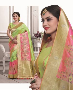 Traditional Yet Pretty Color Pallete Is Here With This Lovely Saree In Light Green And Pink Color Paired With Light Green Colored Blouse. This Saree And Blouse are Fabricated On Art Silk Beautified With Weave. 