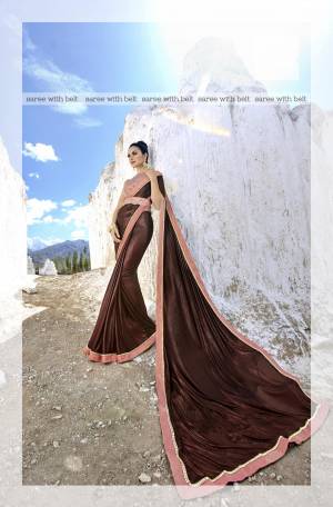 You Will Definitely Earn Lots Of Compliments Wearing  This Designer Saree In Brown Color Paired With Contrasting Baby Pink Colored Blouse. This Saree Is Fabricated On Lycra Paired With Net Fabricated Blouse. It Is Easy To Drape And Carry All Day Long.