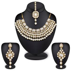 Give An Elegant Look To Your Neckline Wearing This Attractive Necklace Set In Golden Color Beautified With White Colored Stones All Over It.