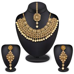 Give An Elegant Look To Your Neckline Wearing This Attractive Necklace Set In Golden Color Beautified With Beige Colored Stones All Over It.