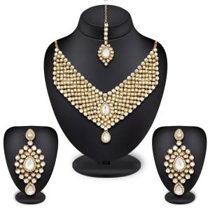 New And Unique Patterned Designer Necklace Set Is Here In Golden Color Beautified With White Colored Stones Which Can Be Paired With Any Colored Ethnic Dress. Buy Now.