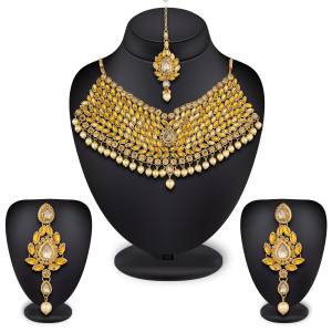 New And Unique Patterned Designer Necklace Set Is Here In Golden Color Beautified With Yellow And Beige Colored Stones Which Can Be Paired With Any Colored Ethnic Dress. Buy Now.
