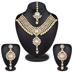 Have A Attractive And Beautiful Look With This Lovely Designer Necklace Set In Golden Color Beautified With White colored Stone Work. It IS Light Weight And Easy To Carry Throughout The Gala.