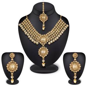 Have A Attractive And Beautiful Look With This Lovely Designer Necklace Set In Golden Color Beautified With Beige And White colored Stone Work. It IS Light Weight And Easy To Carry Throughout The Gala.