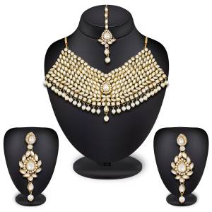 Here Is A Heavy Necklace Set To Pair Up With Your Heavy Ethnic Dress Such As Heavy Lehenga Or Floor Length Suit. This Set Is Also Suitable For Bridal Wear. It Is In Golden Color Beautified With White Colored Stones, Buy Now.