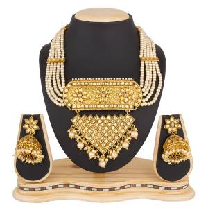 For A Proper Traditonal Look, Grab This Lovely Designer Necklace Set In Golden Color Beautified With Beige Colored Stones And Pearls. This Set Can Be Paired With Any Colored Ethnic Attire. Buy Now.