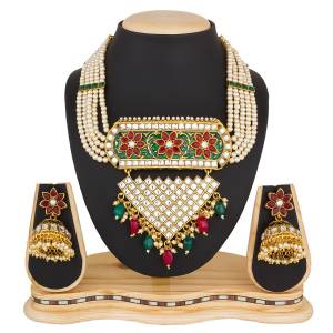 For A Proper Traditonal Look, Grab This Lovely Designer Necklace Set In Golden Color Beautified With Multi Colored Stones And Pearls. This Set Can Be Paired With Any Contrasting Colored Ethnic Attire. Buy Now.