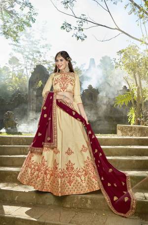 Evergreen Ethnic Combination Is Here With This Lovely Heavy Designer Lehenga Choli In Beige Color Paired With Maroon Colored Dupatta. This Lehenga And Choli Are Fabricated On Soft Silk Paired With Chiffon Dupatta. Its Pretty Color Combination Will Earn You Lots Of Compliments From Onlookers.