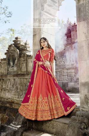 You Will Definitely Earn Lots Of Compliments Wearing This Designer Attractive Colored Lehenga Choli In Orange Color Paired With Contrasting Dark Pink Colored Dupatta. Its Blouse And Lehenga Are Fabricated On Soft Silk Paired With Chiffon Dupatta. Buy This Lehenga Choli Now.