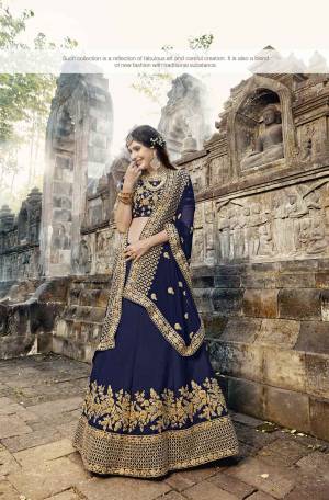 Enhance Your Personality Wearing This Heavy Designer Lehenga Choli In Navy Blue Color Paired With Navy Blue Colored Dupatta. This Lehenga Choli Is Fabricated On Soft Silk Paired With Chiffon Dupatta. It Has Attractive Embroidery Over The Lehenga, Choli And Dupatta Which Will Earn You Lots Of Compliments From Onlookers.