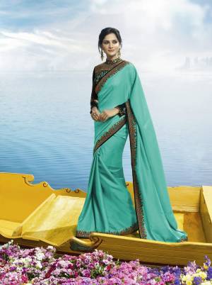 Grab This Beautiful Designer Which Will Earn You Lots Of Compliments From Onlookers, This Pretty Saree Is In Turquoise Blue Color Paired With Dark Green Colored Blouse. This Saree Is Fabricated On Soft Silk Paired With Velvet Fabricated Blouse. Its Heavy Embroidered Blouse And Saree Lace Border Is Making Thr Saree Attractive.
