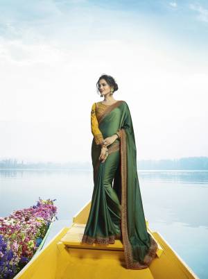 Rich And Elegant Looking Designer Saree Is Here In Dark Green Color Paired With Contrasting Musturd Yellow Colored Blouse. This Saree Is Fabricated On Soft Silk Paired With Art Silk Fabricated Blouse. It Is Light Weight And Easy To Drape. Buy This Saree Now.