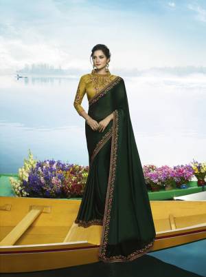 Go With The Shades Of Green With This Designer Saree In Pine Green Color Paired With Contrasting Pear Green Colored Blouse. This Saree Is Fabricated On Soft Silk Paired With Art Silk Fabricated Blouse. It Is Beautified With Contrasting Embroidery Making The Saree And Blouse Attractive.