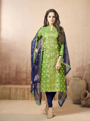 Here Is A Very Pretty Color Combiantion With This Dress Material In Green Colored Top Paired With Contrasting Navy Blue Colored Bottom And Dupatta. Its Top Is Fabricated On Banarasi Art Silk Paired With Cotton Bottom And Chiffon Dupatta. Get This Stitched As Per Your Desired Fit And Comfort.