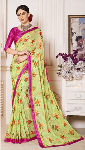 Look Pretty In This Light Green Colored Saree Paired With Contrasting Rani Pink Colored Blouse. This Saree IS Fabricated On Georgette Paired With Satin Fabricated Blouse. It Is Beautified With Contrasting Floral Prints All Over The Saree.