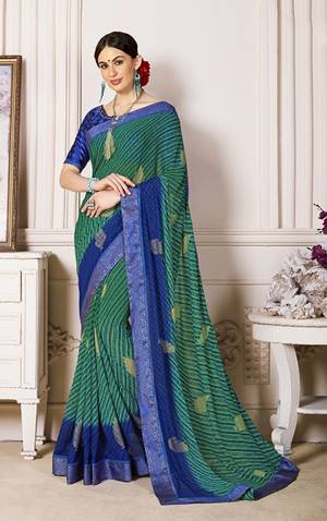 For Your Semi-Casual Wear, Grab This Saree In Green Color Paired With Contrasting Royal Blue Colored Blouse. This Saree Is Fabricated On Georgette Paired With Satin Fabricated Blouse. It Is Soft Towards Skin And Easy To Carry All Day Long.