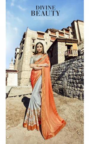New And Unique Color Pallete Is Here With This Designer Saree In Orange And Grey Color Paired With Grey Colored Blouse. This Saree Is Fabricated On Crepe Silk Paired With Art Silk Fabricated Blouse. Buy This Designer Festive Wear Saree Now.