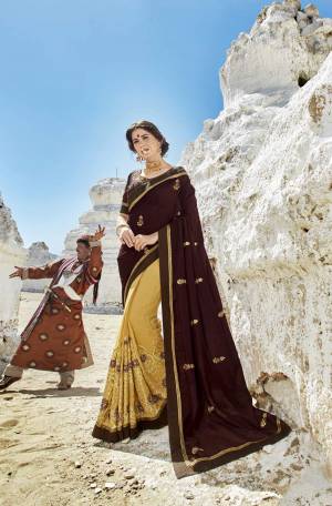 Elegant Color Combination Is Here With This Designer Saree In Brown And Yellow Color Paired With Brown Colored Blouse. This Saree Is Fabricated On Art Silk And Georgette Paired With Art Silk Fabricated Blouse. It Has Heavy Embroidery Over The Skirt Panel.
