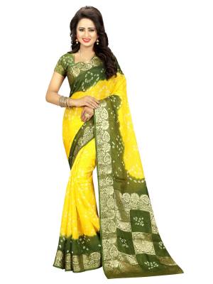 For A Pretty Elegant Festive Look, Grab This Saree In Yellow And Green Color Paired With Green Colored Blouse. This Saree And Blouse Are Fabricated On Art Silk Beautified With Bandhani Prints. 