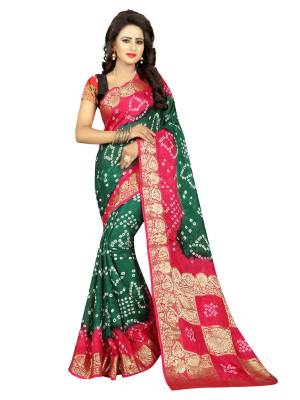 Attract All Wearing This Saree In Pine Green And Pink Color Paired With Pink Colored Blouse. This Saree And Blouse are Fabricated On Art Silk Beautified With Bandhani Prints And Weave.