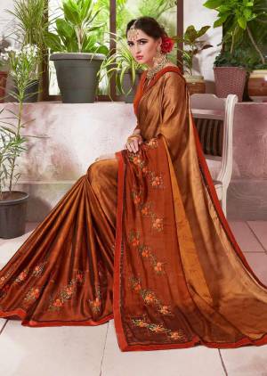 This Season, Step Out With A Different Look Draping This Lovely Saree In Light Brown And Rust Color Paired With Rust Orange Colored Blouse. This Saree IS Fabricated On Crepe Silk Paired With Art Silk Fabricated Blouse. Buy This Saree Now.