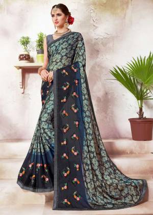 Quite Unique Cmbination Is Here With This Designer Saree In Grey And Navy Blue Color Paired With Navy Blue Colored Blouse. This Saree IS Fabricated On Crepe Silk Paired With Art Silk Fabricated Blouse. Buy Now.